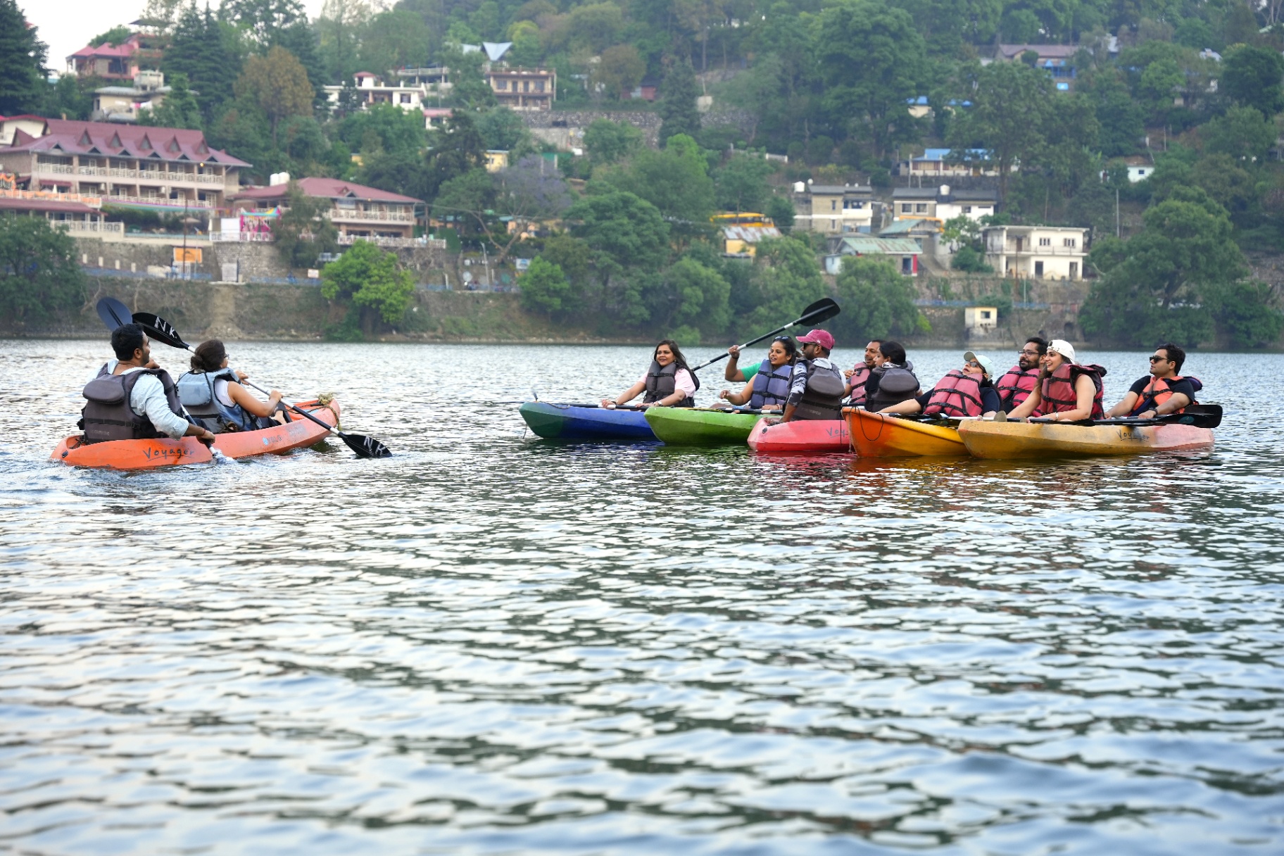 Group kayaking together on a Himalayan lake